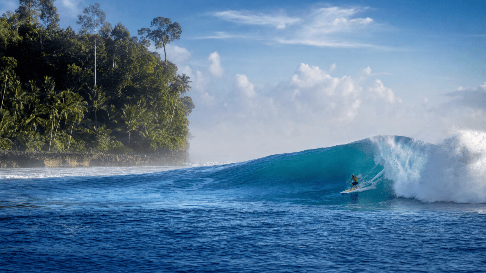 A surfer on a powerful Mentawai wave